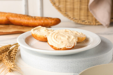 Plate of tasty croutons with cream cheese on table