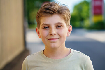 Portrait of handsome preteen school kid boy. Beautiful happy child looking at the camera. Schoolboy smiling. Education concept. Teenager outdoors