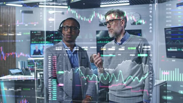 Multiracial financial analysts look on computer generated virtual 3D real-time stocks on glass wall, analyze business strategy in investment bank. Computers and big digital screens on background. - Powered by Adobe