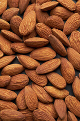 Whole shelled almond nuts kernels studio background