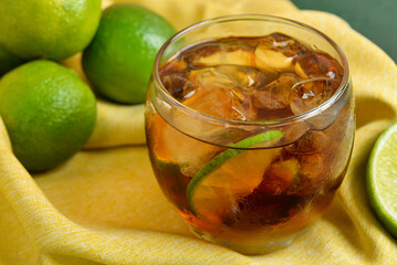Glass of cold Cuba Libre cocktail on table