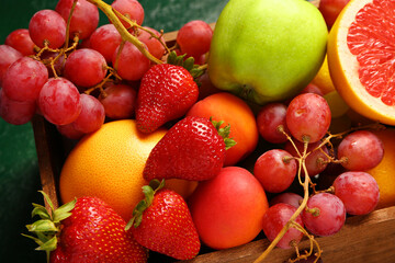 Wooden box with different fresh fruits, closeup