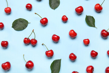 Many sweet cherries on blue background