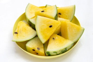 Fototapeta na wymiar Yellow watermelon slices on white background.