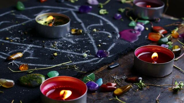 Black magic ritual background with magical altar, candles, crystals and herbs. Sorcerer rite of witchcraft and occultism. Halloween occult, esoteric and divination concept.