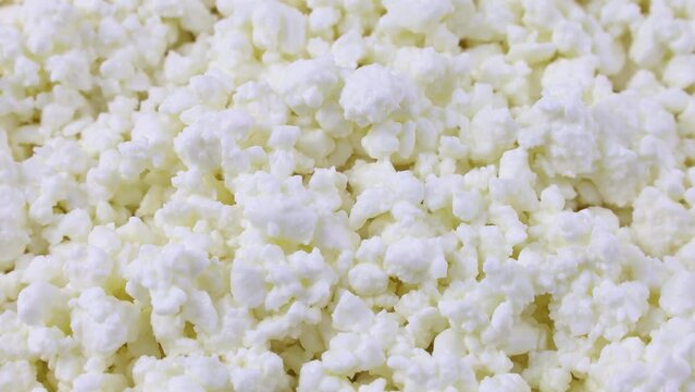 Fresh white cottage cheese texture circle rotation close up