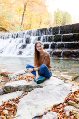young woman tourist near a waterfall in the Austrian forests