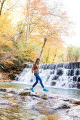 young woman tourist near a waterfall in the Austrian forests
