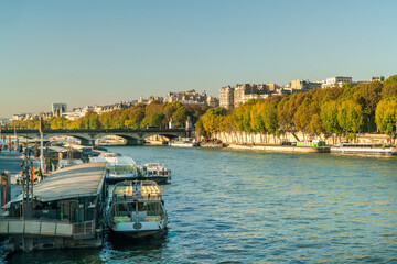 Fototapeta premium Seine river with boats and cityscape of Paris, France