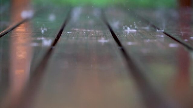 rain drops on wooden floor. slow motion detail. 4k video.