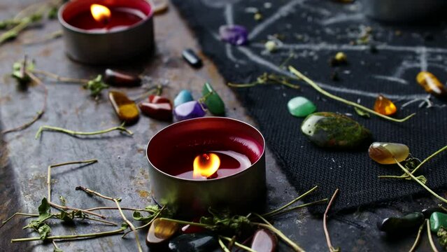 Black magic ritual background with magical altar, candles, crystals and herbs. Sorcerer rite of witchcraft and occultism. Halloween occult, esoteric and divination concept.