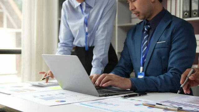 Asian business adviser meeting to analyze and discuss the situation on the financial report in the meeting room. Investment Consultant, Financial Consultant, Financial advisor and accounting concept