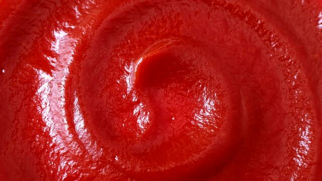 Red tomato ketchup texture circle rotation close up top view