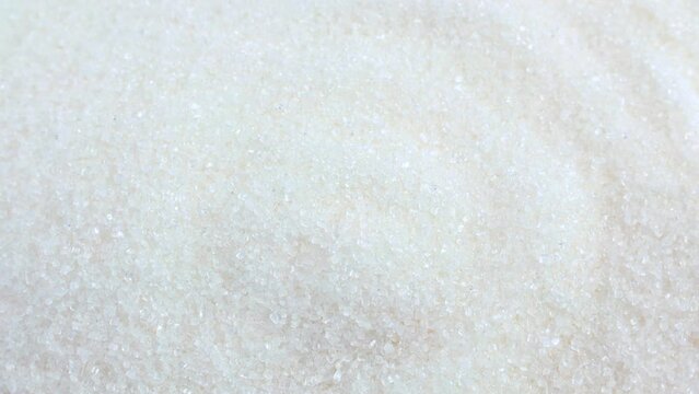 White sugar grains texture circle rotation close up