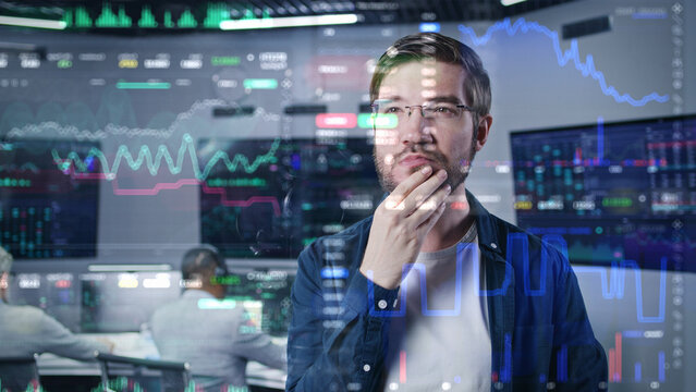 Male investment specialist analyzes cryptocurrency charts in modern office. 3D render of real-time stocks on glass wall. Futuristic AI VFX animation. Computers and big digital screens on background.