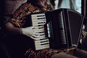 A woman playing the accordion  - obrazy, fototapety, plakaty