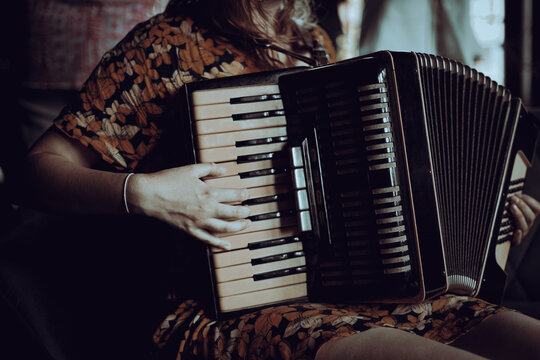 A woman playing the accordion 