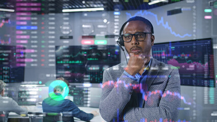 African American investment specialist analyzes real-time stocks in office. 3D graphics of cryptocurrency charts on glass wall. Futuristic VFX animation. Employees work on computers on background.