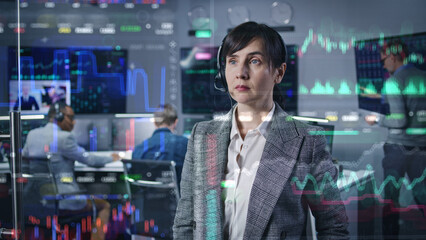 Female stock trader, businesswoman works in broker agency office. 3D abstract AI animation of real-time stocks and cryptocurrency charts on glass wall. Computers and big digital screens on background.