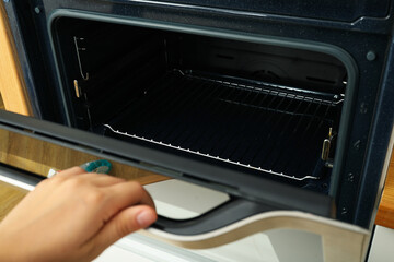 Baking oven, open door, interior view, close-up