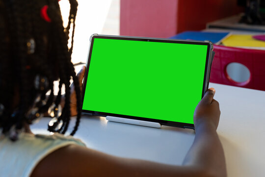 African american schoolgirl having tablet video call with copy space