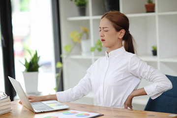 The office syndrome can be caused by sitting in front of a laptop for several hours, concept business woman.