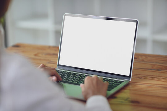 A person working on a laptop in concept business work on the wooden table.