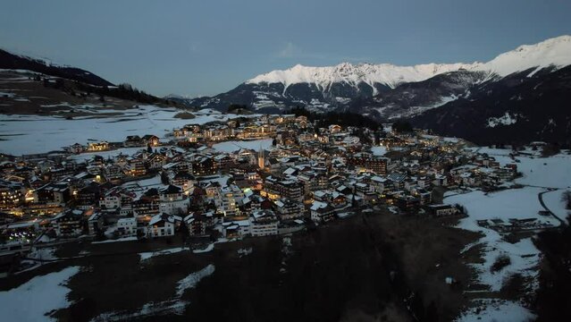 Drone view over Serfaus municipality between snowy mountains in Austria