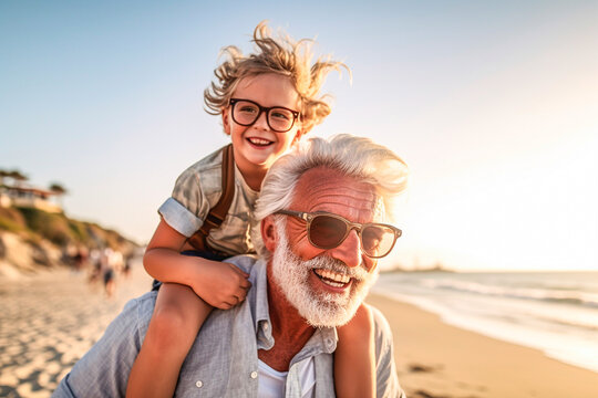 Happy senior man and his grandson on the beach at summer