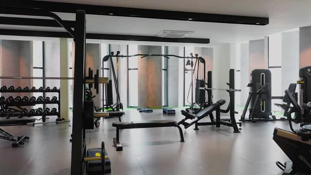 Interior of a gym with modern equipment and big panoramic windows
