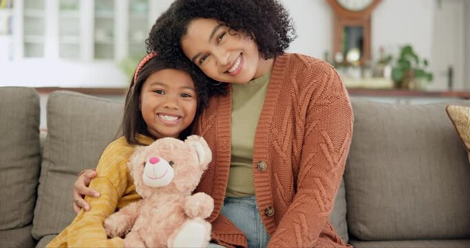 Home, mother and girl on a couch, hug and relax with happiness, loving together and quality time. Face, mama and daughter on a sofa, child development and embrace with a smile, mom and female kid