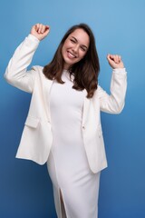 pleasant european brunette young woman in a white dress with cheerful emotions on her face