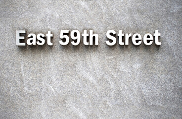 Fototapeta na wymiar 59th street sign on granite wall of a new york city building 