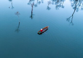 Old man fishing in Tuyen Lam lake, Da Lat city, Lam Dong province, Vietnam