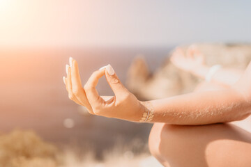 Woman sea yoga. Happy woman meditating in yoga pose on the beach, ocean and rock mountains. Motivation and inspirational fit and exercising. Healthy lifestyle outdoors in nature, fitness concept.