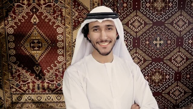 Man wearing traditional white kandura from the emirates spending time in his arab house. Concept about middle eastern cultures and lifestyles