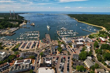 Aerial view of the bustling Port Jefferson Harbor, surrounded by many boats of various sizes