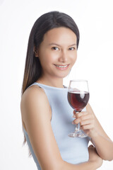Beautiful Asian woman smiling and holding glass of red wine