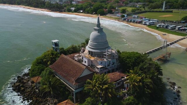 Aerial of the Matara Paravi Duwa temple surrounded by the sea in Sri Lanka