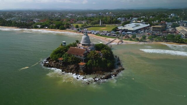 Aerial of the Matara Paravi Duwa temple surrounded by the sea in Sri Lanka