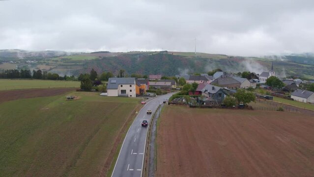 Cars driving towards Bourscheid at Luxembourg during a moody day, aerial