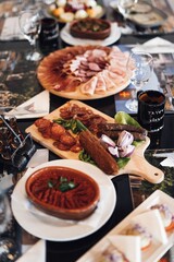 Black table adorned with a variety of food and beverages.