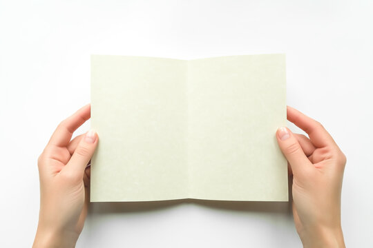 female hands holding an open blank postcard on white background