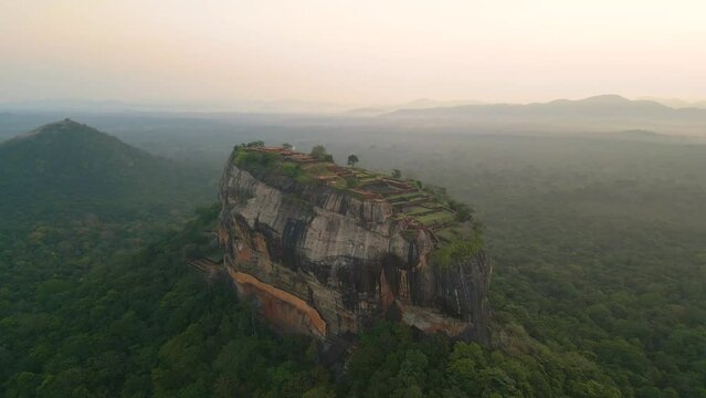 Aerial of the Lion Rock or Sigiriya mountain in Sri Lanka surrounded by the dense green forest