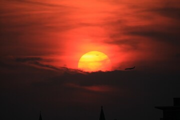 Stunning sunset with silhouetted airplanes illuminated in the golden light of the setting sun