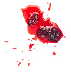 Squashed ripe sour cherry in the puddle of red juice isolated on white