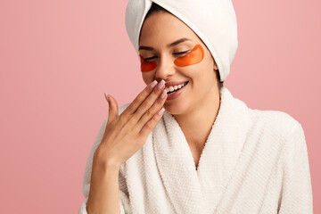 Content woman with eye patches smiling after shower
