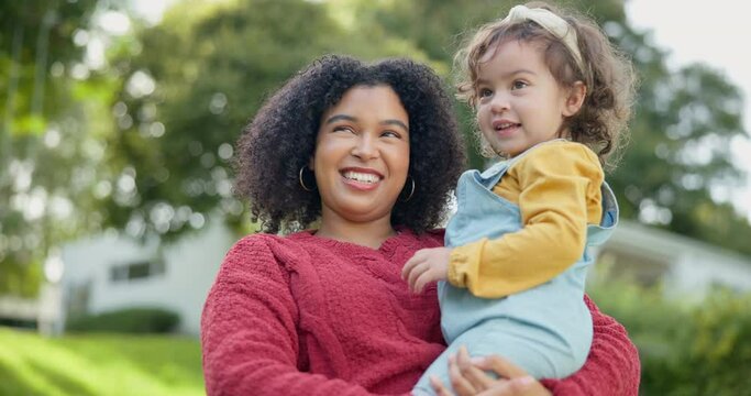 Family, children and a mother with her adopted daughter in the garden of their foster home together. Love, smile and kids with a stepmother holding her female child outdoor in the home backyard