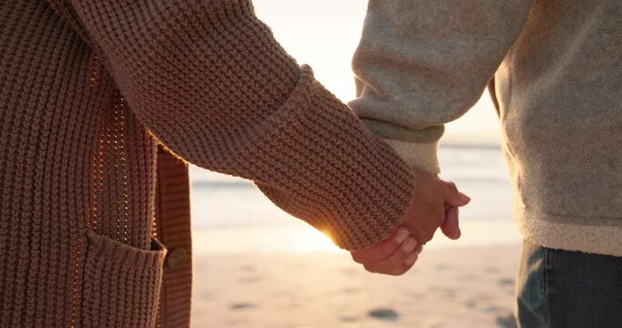 Love, beach and senior couple holding hands by ocean for commitment, bonding and quality time at sunset. Marriage, travel and man and woman embrace for romance on holiday, vacation and anniversary