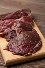 Raw fresh roe deer meat, fillet on a cutting board